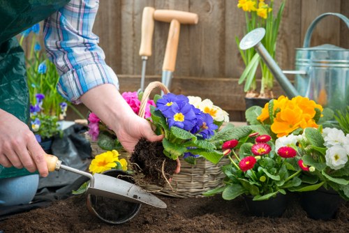 Worker wearing PPE operating a garden chipper